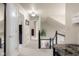 Bright hallway with a view of the staircase, and neutral walls, creating a welcoming and airy transition between spaces at 6096 E Conestoga Trl, Columbus, IN 47203