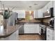 Modern kitchen with white cabinets, stainless steel appliances, and decorative backsplash at 6096 E Conestoga Trl, Columbus, IN 47203