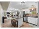 Open kitchen with a center island, stainless steel appliances, and a glimpse of a fireplace at 6096 E Conestoga Trl, Columbus, IN 47203