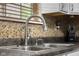 Detailed view of a modern stainless steel kitchen sink with a pull-down faucet at 6096 E Conestoga Trl, Columbus, IN 47203
