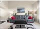 Inviting living room with a gray sofa, red pillows, and a unique coffee table at 6096 E Conestoga Trl, Columbus, IN 47203