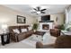 Cozy living room with fireplace, flat screen tv, ceiling fan, and brown furniture at 6096 E Conestoga Trl, Columbus, IN 47203