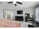 Bedroom with a dresser, mounted TV, a stationary bicycle and an ensuite bathroom for ultimate comfort and privacy at 6096 E Conestoga Trl, Columbus, IN 47203