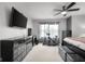 Bedroom with a full dresser, stationary bicycle, and a mounted TV, ideal for fitness and entertainment at 6096 E Conestoga Trl, Columbus, IN 47203