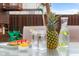 Pineapple, cucumber water, watermelon, and lemons on a clear outdoor table at 6096 E Conestoga Trl, Columbus, IN 47203