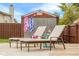 Backyard deck with lounge chairs, shed, and privacy fence creates a relaxing outdoor living space at 6096 E Conestoga Trl, Columbus, IN 47203