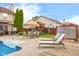 Backyard with in-ground pool, lounge chairs, table, play set, and hot tub for great entertaining at 6096 E Conestoga Trl, Columbus, IN 47203