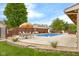 A spacious backyard showcasing a stunning in-ground pool, and ample lounging and dining areas at 6096 E Conestoga Trl, Columbus, IN 47203