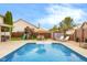 Backyard with in-ground pool, play set, lounge chairs, and an umbrella for great entertaining at 6096 E Conestoga Trl, Columbus, IN 47203