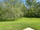 Expansive, well-maintained backyard featuring mature trees and a serene, natural setting at 625 Streamside Dr, Greenfield, IN 46140