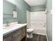 Bathroom with stylish vanity, modern sink, and tub/shower combination, all with wood-look floors at 625 Streamside Dr, Greenfield, IN 46140