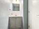Chic half bathroom with a modern vanity, stylish mirror, and elegant lighting at 625 Streamside Dr, Greenfield, IN 46140