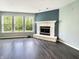 Cozy living room featuring a stone fireplace and large windows with picturesque outdoor views at 625 Streamside Dr, Greenfield, IN 46140
