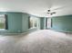 Bright main bedroom features neutral carpet, recessed lighting, and three large windows at 625 Streamside Dr, Greenfield, IN 46140