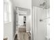 Bathroom showcasing a shower stall and hallway view into a laundry room at 645 W Stop 11 Rd, Indianapolis, IN 46217