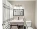 Renovated bathroom with new vanity, modern lighting, and patterned shower curtain at 645 W Stop 11 Rd, Indianapolis, IN 46217