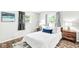 Comfortable bedroom featuring neutral tones, natural light, and simple wood furnishings at 645 W Stop 11 Rd, Indianapolis, IN 46217