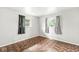 Bright bedroom with two large windows, neutral walls, and patterned flooring at 645 W Stop 11 Rd, Indianapolis, IN 46217