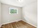 Empty bedroom with light gray walls and hardwood floors shows natural light at 645 W Stop 11 Rd, Indianapolis, IN 46217