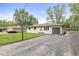 Ranch-style home with a driveway and basketball hoop provides curb appeal at 645 W Stop 11 Rd, Indianapolis, IN 46217