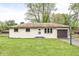 Charming ranch-style home features a well-maintained lawn and attached garage at 645 W Stop 11 Rd, Indianapolis, IN 46217