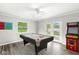 Spacious game room featuring a pool table, arcade game, neutral walls, and a walkout at 645 W Stop 11 Rd, Indianapolis, IN 46217