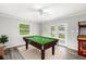 Spacious game room with a pool table, arcade game, neutral walls, and a walkout at 645 W Stop 11 Rd, Indianapolis, IN 46217