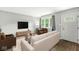 Bright living room showcasing modern furniture, hardwood floors, and a large window with tons of light at 645 W Stop 11 Rd, Indianapolis, IN 46217