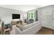 Bright living room featuring modern furniture, hardwood floors, and a large window with natural light at 645 W Stop 11 Rd, Indianapolis, IN 46217