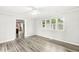 Bright living room with gray wood-look flooring and a large sunny window at 645 W Stop 11 Rd, Indianapolis, IN 46217