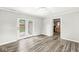 Bright living room with gray wood-look flooring and access to the outdoors and the kitchen at 645 W Stop 11 Rd, Indianapolis, IN 46217