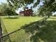 Spacious backyard with lush lawn, a two-story home, and secure fencing at 7140 N Michigan Rd, Fairland, IN 46126