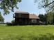 Exterior view of the house featuring a deck and a two-story design on a verdant lawn at 7140 N Michigan Rd, Fairland, IN 46126