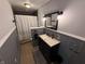 Cozy bathroom featuring a shower, stylish vanity, beadboard walls, and patterned tile flooring at 7140 N Michigan Rd, Fairland, IN 46126