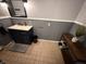 Well-lit bathroom featuring a vanity, decorative rug, and an elegant wood shelf for storage at 7140 N Michigan Rd, Fairland, IN 46126