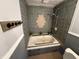 Bathroom with an inset tub, custom tile surround, and practical shower attachment for a spa-like experience at 7140 N Michigan Rd, Fairland, IN 46126