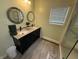 Contemporary bathroom featuring double vanity, stylish mirrors, and a glass-enclosed shower at 7140 N Michigan Rd, Fairland, IN 46126