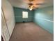 Inviting bedroom boasts a ceiling fan, neutral carpet, and soft aqua walls for a relaxing atmosphere at 7140 N Michigan Rd, Fairland, IN 46126