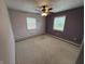 Bright bedroom with neutral carpet, ceiling fan, and ample natural light creates a comforting space at 7140 N Michigan Rd, Fairland, IN 46126