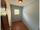 Light-filled bedroom featuring hardwood floors, blue walls, and a window with outdoor views at 7140 N Michigan Rd, Fairland, IN 46126