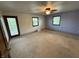 Bedroom with ample natural light, ceiling fan, and door to the outside at 7140 N Michigan Rd, Fairland, IN 46126