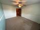 Bedroom with a ceiling fan, neutral carpet, and a view into a large, built-in closet at 7140 N Michigan Rd, Fairland, IN 46126