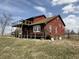 Charming exterior view featuring a wooden deck, and a brick walkway entrance at 7140 N Michigan Rd, Fairland, IN 46126