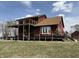Elevated home exterior showcasing a spacious wooden deck, perfect for outdoor relaxation and enjoyment at 7140 N Michigan Rd, Fairland, IN 46126