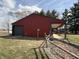 View of one-story home with red siding, garage, covered porch, and a brick-lined walkway at 7140 N Michigan Rd, Fairland, IN 46126