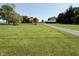 Sprawling green lawn of a beautiful country estate with a charming home and outbuilding at 7140 N Michigan Rd, Fairland, IN 46126