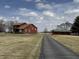 Beautiful home exterior featuring a long driveway and a well-maintained barn on a large property at 7140 N Michigan Rd, Fairland, IN 46126