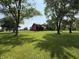 Estate home with a two-story deck and mature trees, surrounded by a large lawn at 7140 N Michigan Rd, Fairland, IN 46126