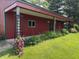 Outbuilding with a green roof and landscaped garden beds along the back porch at 7140 N Michigan Rd, Fairland, IN 46126
