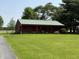 Outbuilding on a lush green lawn; perfect for storage or a workshop at 7140 N Michigan Rd, Fairland, IN 46126